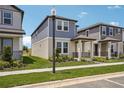 Corner view of a two-story home with tidy landscaping and nearby street lamp at 5139 Passion Flower Way, Winter Garden, FL 34787