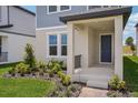 Inviting front porch with columns, manicured landscaping, and a stylish entry door at 5139 Passion Flower Way, Winter Garden, FL 34787