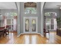 Grand entryway with double doors, high ceilings, large windows, and wood flooring providing a bright, welcoming atmosphere at 889 Kensington Gardens Ct, Oviedo, FL 32765