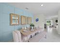 Dining room with blue accent wall, table setting, and bench seating at 1021 Victoria Parc Ave, Orange City, FL 32763