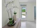 Welcoming foyer with tile flooring, decorative mirror, and view to the front door at 1021 Victoria Parc Ave, Orange City, FL 32763