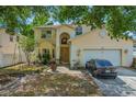 Charming two-story home featuring a well-manicured lawn and attached two-car garage at 1188 Foxforrest Cir, Apopka, FL 32712