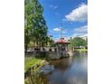 Exterior lake view of the community gazebo by the water at 12539 Floridays Resort Dr Dr # 208D, Orlando, FL 32821