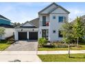 Charming two-story home featuring a well-manicured lawn, a 2-car garage, and balcony at 14749 Walcott Ave, Orlando, FL 32827