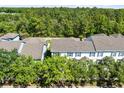 Aerial view of townhouse community with mature trees and landscaping offers a serene setting at 14751 Clarkson Dr, Orlando, FL 32828