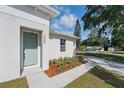 Exterior view of a home featuring a light-green front door and landscaped walkway at 1620 Haddock St, St Cloud, FL 34771