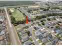 Aerial view of the property in a suburban neighborhood, with proximity to a golf course at 1631 Oak Hill Trl, Kissimmee, FL 34747