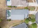 Aerial view of a home with a screened-in pool and well-maintained yard, surrounded by neighboring houses at 1631 Oak Hill Trl, Kissimmee, FL 34747