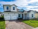 Charming two-story home featuring a three-car garage, beautiful stone accents, and a well-manicured lawn at 19065 Blueleaf St, Orlando, FL 32827