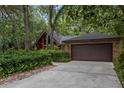 Beautiful home with a large two-car garage and brick exterior, surrounded by trees at 2114 Bluff Oak St, Apopka, FL 32712