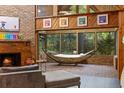The sunroom includes brick floors, windows overlooking the trees, and a hammock at 2114 Bluff Oak St, Apopka, FL 32712