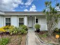 Inviting front porch with decorative plants, a tiled floor and space for comfortable seating at 2673 Dixie Ln, Kissimmee, FL 34744