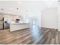 Open-concept living space connects the kitchen and living room, offering a seamless flow for entertaining at 408 Lily Ln, Davenport, FL 33837