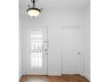 Bright entryway features a glass-paneled front door, hardwood floors, and a modern light fixture at 456 Harbor Winds Ct, Winter Springs, FL 32708