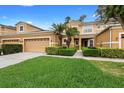 Charming two-story home with well-maintained lawn and landscaping features a large two-car garage at 456 Harbor Winds Ct, Winter Springs, FL 32708