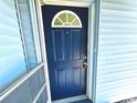 This property boasts a navy blue front door with half moon window and matching screen door at 511 S Alder Ave, Orlando, FL 32807
