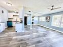 Open-concept living room featuring a modern kitchen, stylish floors, and bright natural light at 511 S Alder Ave, Orlando, FL 32807