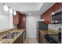 Charming kitchen with granite counters, stainless steel appliances, and tile flooring at 5156 Conroy Rd # 1124, Orlando, FL 32811