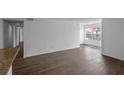 Inviting living room boasting wood-look floors, neutral walls, and lots of natural light from large windows at 5156 Conroy Rd # 1124, Orlando, FL 32811