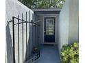 Enclosed front porch with black metal gate and inviting door with glass detail providing character and charm at 567 E Orange St # 567, Altamonte Springs, FL 32701
