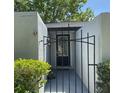 Gated entryway with black iron fencing and decorative plants offering security and privacy to the home's entrance at 567 E Orange St # 567, Altamonte Springs, FL 32701