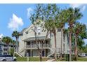 Comfortable condo with a welcoming outdoor entryway and lovely tropical landscaping at 6142 Westgate Dr # 204, Orlando, FL 32835