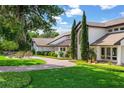 Elegant home with brick driveway, manicured lawn, and lush greenery at 645 Manor Rd, Maitland, FL 32751