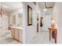 Bright bathroom featuring a single sink vanity with ample counter space, adjacent to the entryway of the home at 682 Lexington Dr, Clermont, FL 34711