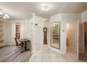 Spacious foyer with tile flooring, a decorative mirror, and a view into the home at 7420 Cypress Grove Rd # 132, Orlando, FL 32819