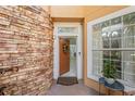 Inviting front entry with tiled landing, stone facade and window providing ample sunlight at 7420 Cypress Grove Rd # 132, Orlando, FL 32819
