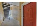 Exterior entryway featuring a bright red door and stairs at 8213 Claire Ann Dr # 108, Orlando, FL 32825