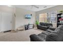Living room with neutral carpet and a large window for ample natural light at 8213 Claire Ann Dr # 108, Orlando, FL 32825