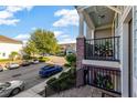 Charming townhome balcony overlooking a tree-lined street, enhanced with decorative plants at 861 Taramundi Dr, Oviedo, FL 32765