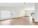 Open living space with modern lighting fixtures, lots of windows and wood-look floors at 142 Placid Woods Ct, Sanford, FL 32773