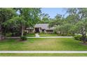 Charming single-story home with mature trees and landscaped front yard, perfect for enjoying the outdoors at 554 Estates Pl, Longwood, FL 32779