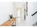 Bright foyer with marble flooring, a wooden console table, and a decorative 'welcome' sign at 1013 Leader St, Davenport, FL 33896