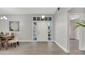 Bright, open foyer with a view of the dining area, featuring stylish flooring and a decorative front door at 1027 Dees Dr, Oviedo, FL 32765