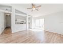 Bright living room with wood floors, ceiling fan, and sliding doors to the outdoors at 1073 Hamlet Dr, Maitland, FL 32751