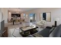 Bright living room showcasing an open layout and seamless transition into the dining and kitchen areas at 12915 Trovita Dr, Grand Island, FL 32735