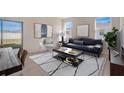 Cozy living room featuring modern decor and ample natural light with the view to the backyard at 12915 Trovita Dr, Grand Island, FL 32735