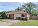 Inviting home exterior with a cozy design, showcasing a well-kept lawn and mature landscaping at 1397 Candlewyck Dr, Orlando, FL 32807