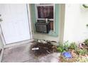 Exterior view featuring a door and window unit air conditioner at 14057 Ithaca Way, Orlando, FL 32826
