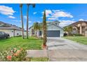 Beautiful two-story home boasts mature landscaping including palm trees and a well-manicured lawn at 1517 Abberton Dr, Orlando, FL 32837