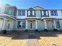 Brand new townhouse with covered entrance and brick walkway, still under construction at 15310 Burgtheater Dr, Winter Garden, FL 34787