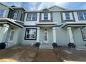 Newly constructed townhouse with a covered entrance, awaiting landscaping at 15310 Burgtheater Dr, Winter Garden, FL 34787