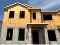 Construction view of the two-story townhome showing the framing and cinder block on a sunny day at 15363 Burgtheater Dr, Winter Garden, FL 34787