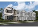 Charming two-story townhome featuring a covered entry, decorative shutters, and well-manicured landscaping at 15363 Burgtheater Dr, Winter Garden, FL 34787