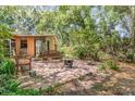 Tranquil backyard patio with a wooden bench, perfect for outdoor relaxation at 1860 Ne 62Nd St, Ocala, FL 34479