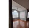 Bright living room with vaulted ceiling, large windows, and hardwood floors at 2202 Key West Ct # 633, Kissimmee, FL 34741