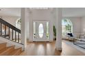 Bright foyer with hardwood floors, staircase, and large windows offers a welcoming entry at 2233 Blossomwood Dr, Oviedo, FL 32765